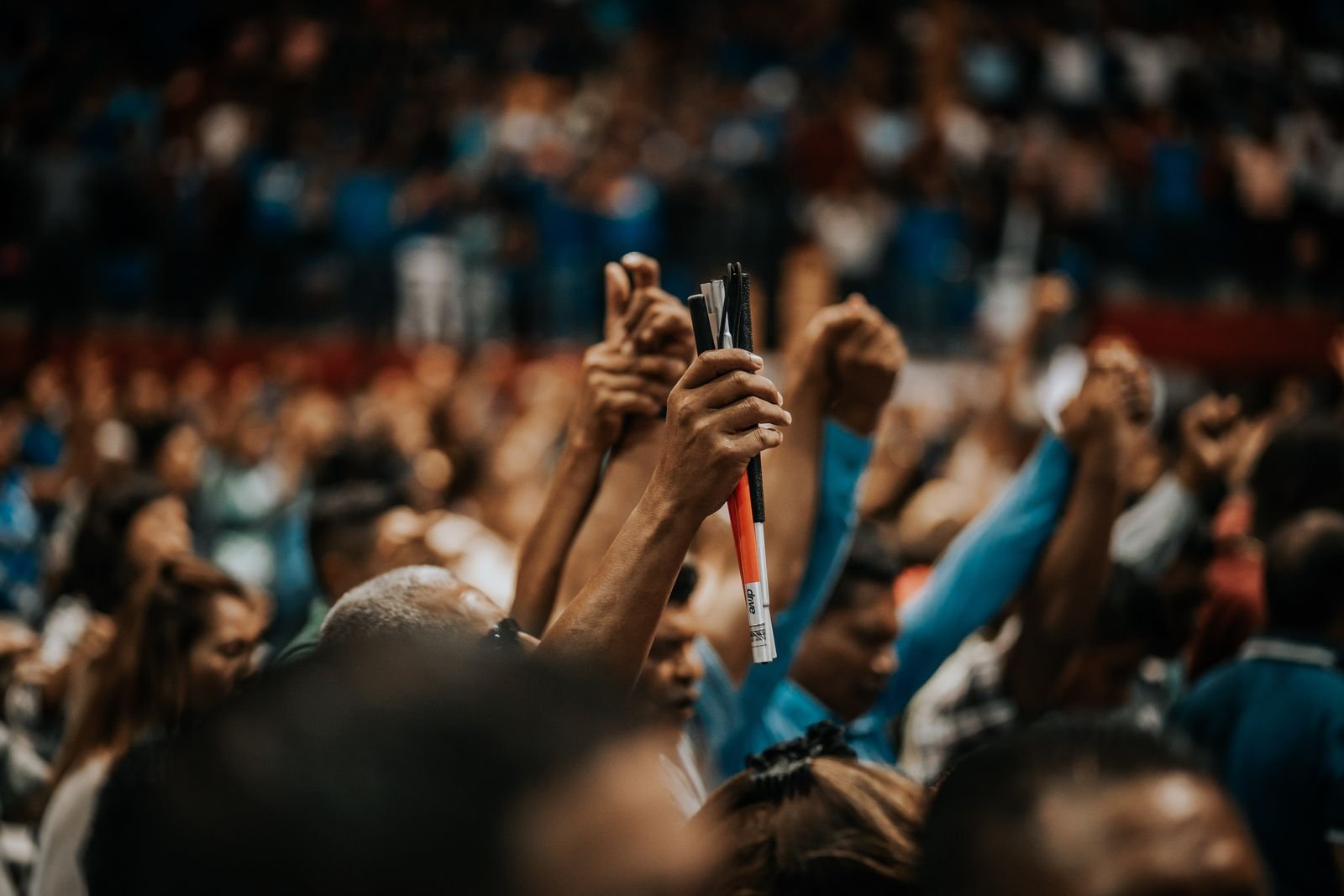 The City of Joy congregation worshipping with hands raised