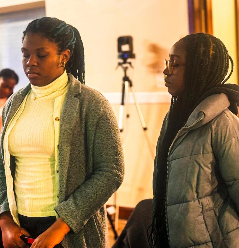 Members of City of Joy in prayer